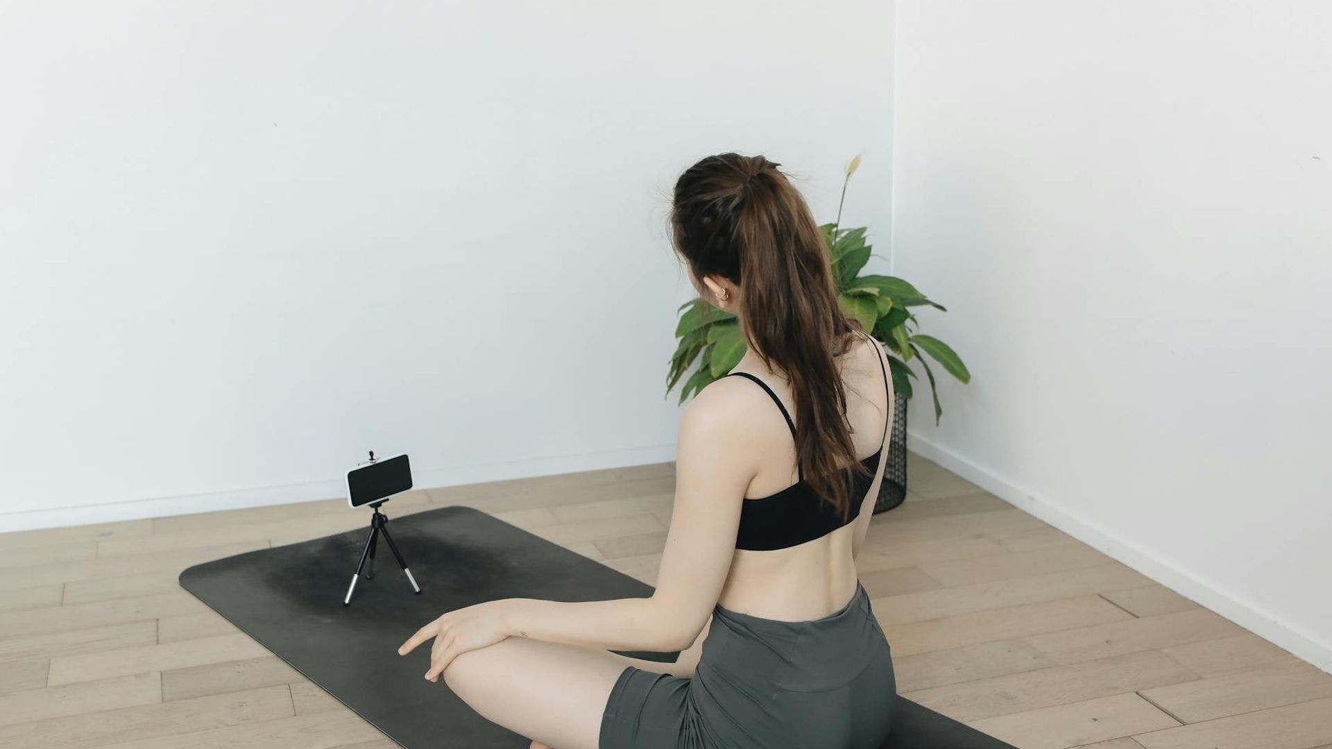 Person doing dynamic exercises in a bright minimalist studio